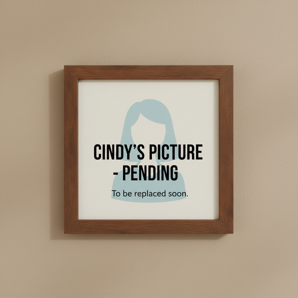 A framed sign on a wall displays a placeholder graphic for Cindy's picture with the text "Cindy's picture - pending, to be replaced soon."